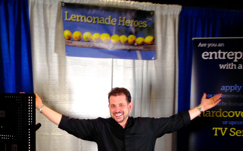 Aaron Sylvan interviewing entrepreneurs in the Lemonade Heroes booth at Javits Convention Center