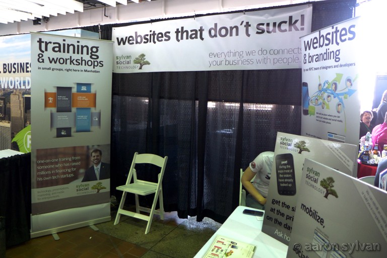 Sylvan Social Technology booth at Small Business Expo, advertising "Websites that don't suck", as well as Training, Workshops, and Branding.