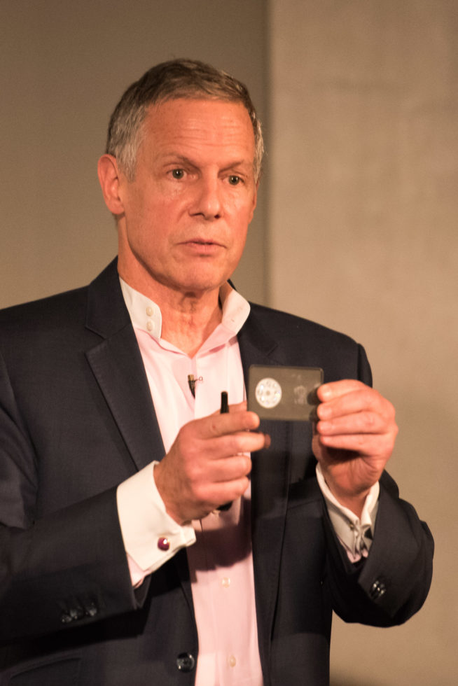 Joseph Lipton showing a real sample of his $100,000 diamond-backed currency (TEDxFultonStreet photo by Eriq Ortiz) 2016-09-21