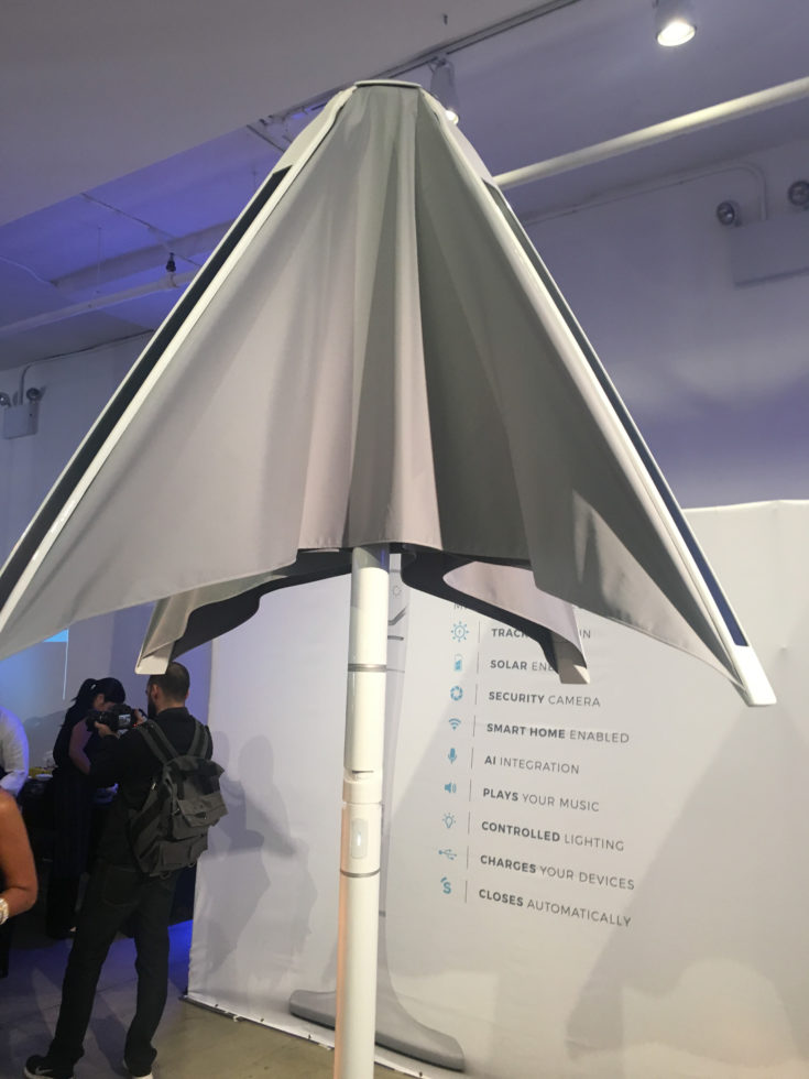 $2700 Picnic Umbrella that tracks the sun, includes WiFi, security cameras, and more... at Luxury Technology Show (iPhone pic by Aaron Sylvan) taken 2017-10-04