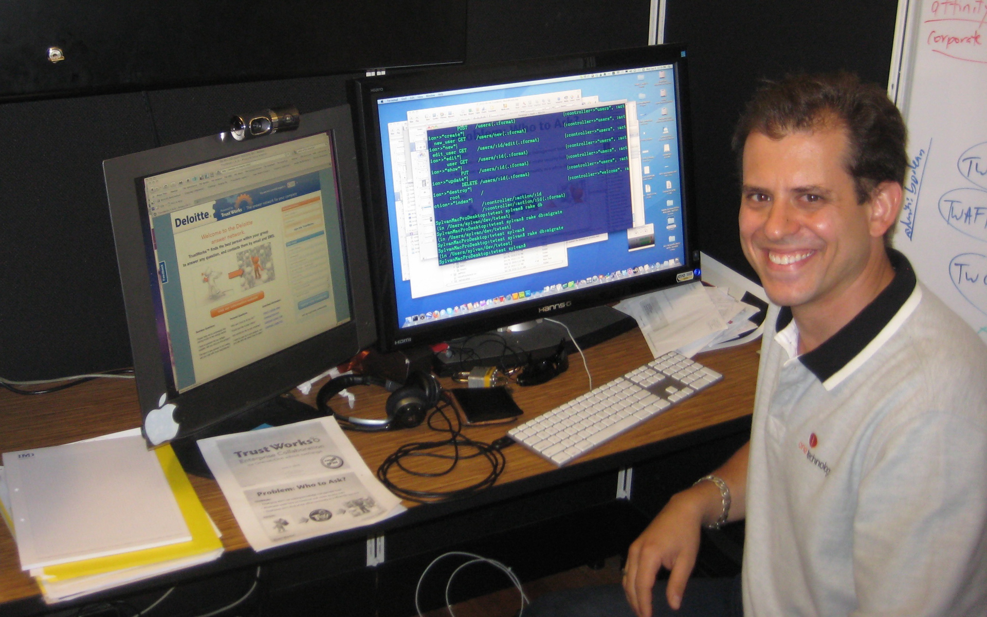Aaron Sylvan customizing a Deloitte-branded TrustWorks implementation at a two-monitor workstation